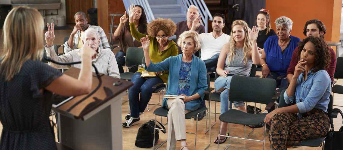 Group Attending Neighborhood Voting In Community Center