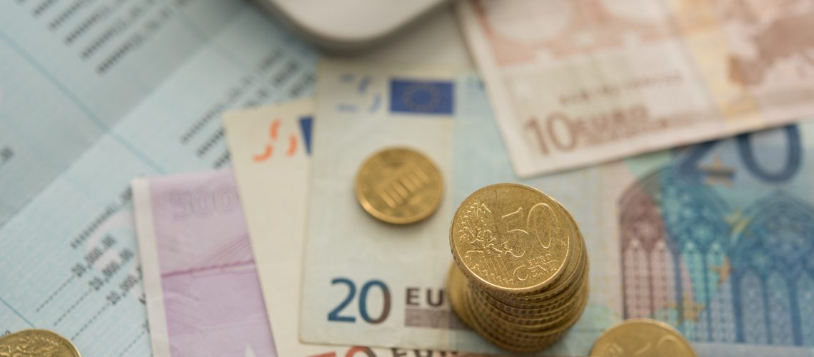 personal financial planning concept. euro money on bank account passbook with calculator on desk.