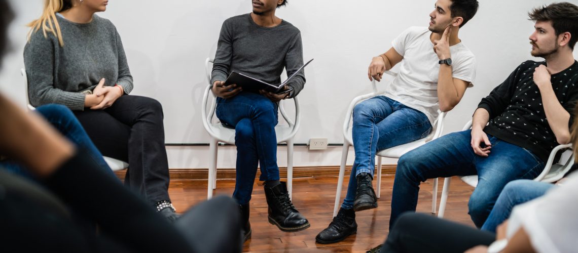 Group of multiethnic creative business people working on a project and having a brainstorming meeting. Team work and brainstorming concept.