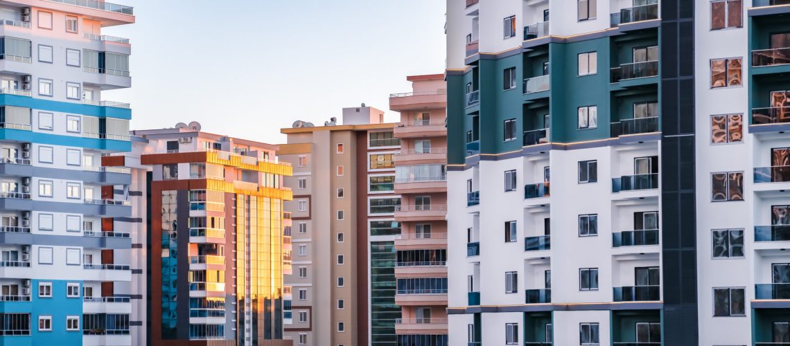 Fragments of facades of modern multi-storey residential buildings, side view, close-up. Banner