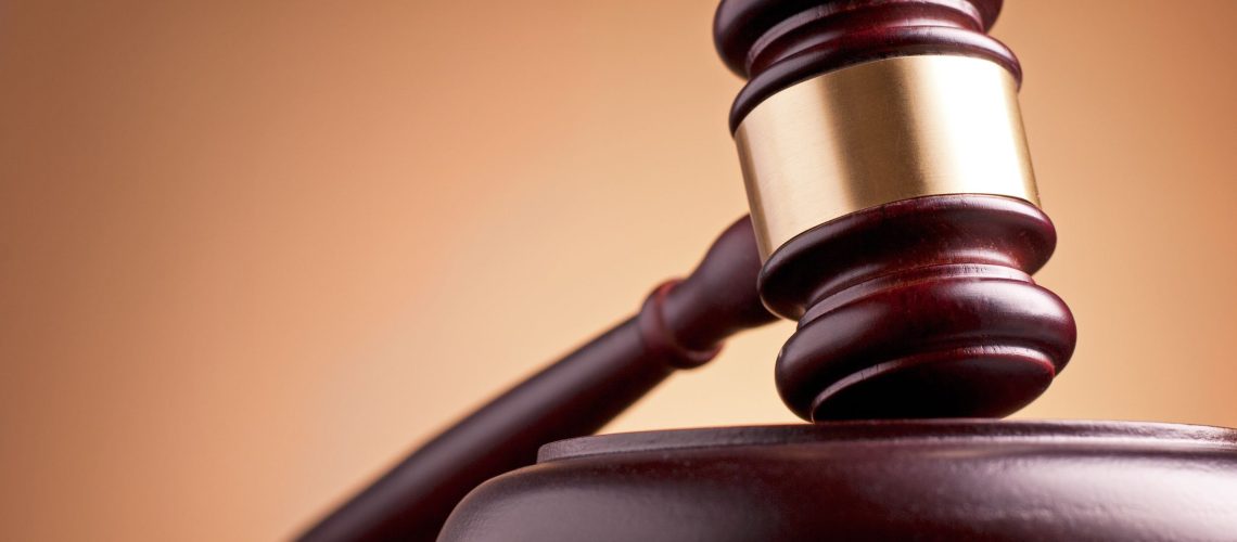 20199243 - brown gavel on the table on a brown background