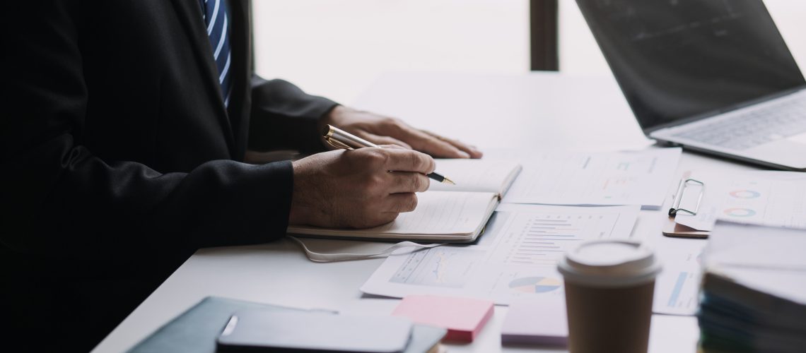 Businesswoman or accountant working Financial investment on calculator, calculate, analyze business and marketing growth on financial document data graph, Accounting, Economic, commercial concept.