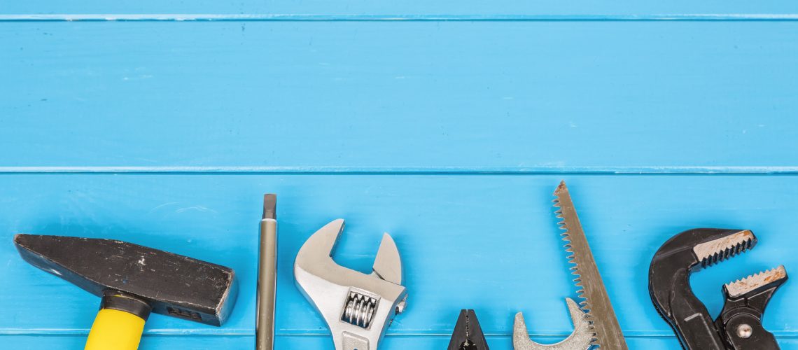 View of work tools on blue wooden background